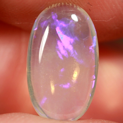 SOLID CRYSTAL OPAL Transparent with purple and green moving within